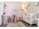 Bright Bedroom with crib, play tent, and shelving for books at 20150 E Fair Ln, Centennial, CO 80016