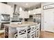 Modern kitchen with white cabinets, granite countertops, and stainless steel appliances at 20150 E Fair Ln, Centennial, CO 80016