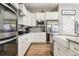 Modern kitchen with white cabinets, granite countertops, and a farmhouse sink at 20150 E Fair Ln, Centennial, CO 80016