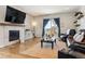 Living room with hardwood floors, fireplace, and a large TV at 20150 E Fair Ln, Centennial, CO 80016