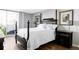 Bedroom with a four post bed, hardwood floors, and a sliding glass door to a balcony at 909 N Logan St # 3A, Denver, CO 80203