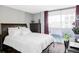 Bedroom with a comfortable bed and sliding glass door to a balcony at 909 N Logan St # 3A, Denver, CO 80203