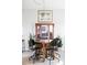 Comfortable dining area with glass table, modern chairs, and snake plants at 909 N Logan St # 3A, Denver, CO 80203