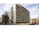 A multi-story condo building with private balconies, landscaped surroundings, and a covered entryway at 909 N Logan St # 3A, Denver, CO 80203