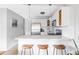 Bright kitchen features white cabinets, stainless steel appliances, and breakfast bar seating at 909 N Logan St # 3A, Denver, CO 80203