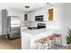 Bright modern kitchen with stainless steel appliances, white cabinets, and breakfast bar at 909 N Logan St # 3A, Denver, CO 80203