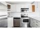 Modern kitchen with stainless steel appliances, white subway tile, and stylish white cabinets at 909 N Logan St # 3A, Denver, CO 80203