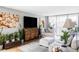 Bright and inviting living room featuring comfortable seating, a large TV, and indoor plants at 909 N Logan St # 3A, Denver, CO 80203