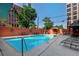 Outdoor pool area with chaise lounges, orange privacy wall, and gazebo at 909 N Logan St # 3A, Denver, CO 80203