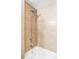 Bathroom showing a tiled shower and tub with updated chrome shower head and faucet fixtures at 909 N Logan St # 3A, Denver, CO 80203