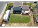 Aerial view of a well-maintained backyard and deck with a lush green lawn at 13915 W 73Rd Ave, Arvada, CO 80005