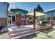 Spacious backyard deck featuring ample seating, shade and outdoor dining at 13915 W 73Rd Ave, Arvada, CO 80005