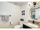 Powder room featuring a granite countertop vanity, black hardware, and decorative accents at 13915 W 73Rd Ave, Arvada, CO 80005