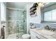 Tiled bathroom featuring a glass shower with mosaic tile, and a sink with a marble countertop at 13915 W 73Rd Ave, Arvada, CO 80005