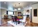 Dining area featuring an open-concept layout, hardwood floors, stylish lighting, and plenty of space at 13915 W 73Rd Ave, Arvada, CO 80005