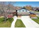 Charming two-story home with a well-manicured lawn and a spacious two car garage at 13915 W 73Rd Ave, Arvada, CO 80005