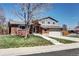 Two-story home with brick accents, an attached two car garage, and well manicured lawn at 13915 W 73Rd Ave, Arvada, CO 80005