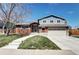 Charming two-story home with well-manicured lawn, brick accents, and attached two-car garage at 13915 W 73Rd Ave, Arvada, CO 80005