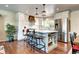 Modern kitchen with stainless steel appliances, a large island, and ample counter space at 13915 W 73Rd Ave, Arvada, CO 80005