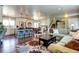 Open-concept living room with hardwood floors, seamlessly connects the kitchen, dining area and living area at 13915 W 73Rd Ave, Arvada, CO 80005