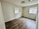 Well-lit bedroom featuring laminate floors and multiple windows offering natural light at 1170 Elmira St, Aurora, CO 80010