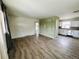 Inviting living room showcasing hardwood flooring and open layout with a view into the kitchen at 1170 Elmira St, Aurora, CO 80010