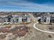 Aerial view showcases a gray home with backyard landscaping, a walking path, and neighboring houses at 6977 Copper Sky Cir, Castle Pines, CO 80108