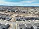 Panoramic aerial view features neighborhood homes, walking paths, and open spaces with scenic views at 6977 Copper Sky Cir, Castle Pines, CO 80108