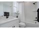 Modern bathroom with white vanity and dark hardware with white walls and neutral accents at 6977 Copper Sky Cir, Castle Pines, CO 80108
