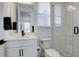 Modern bathroom features a sleek vanity, toilet, and glass-enclosed shower with white tile and stylish fixtures at 6977 Copper Sky Cir, Castle Pines, CO 80108