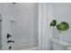 Clean bathroom featuring tiled walls, a shower, and a neutral color palette at 6977 Copper Sky Cir, Castle Pines, CO 80108