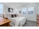 Bright bedroom featuring a comfortable bed, modern decor, and ample natural light from multiple windows at 6977 Copper Sky Cir, Castle Pines, CO 80108
