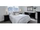 Bright bedroom featuring a comfortable bed, modern decor, and ample natural light from the window at 6977 Copper Sky Cir, Castle Pines, CO 80108