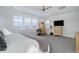 Spacious bedroom offers natural light with multiple windows and is decorated with modern furniture and neutral colors at 6977 Copper Sky Cir, Castle Pines, CO 80108