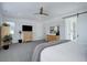 Spacious bedroom with natural light, neutral walls, carpeting, a ceiling fan, and simple furniture at 6977 Copper Sky Cir, Castle Pines, CO 80108