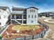 Two-story home featuring a fenced yard, attractive landscaping, a covered patio and a convenient backyard staircase at 6977 Copper Sky Cir, Castle Pines, CO 80108