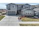 Beautiful gray two-story house with a well-manicured front yard and a two-car garage at 6977 Copper Sky Cir, Castle Pines, CO 80108
