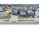 Well-maintained two-story gray home with a driveway, a manicured lawn, and attached garages at 6977 Copper Sky Cir, Castle Pines, CO 80108