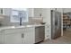 Kitchen with stainless steel appliances, sleek cabinetry, quartz counters, and light gray backsplash tiles at 6977 Copper Sky Cir, Castle Pines, CO 80108