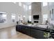 Spacious living room with soaring ceilings, fireplace, and large windows at 6977 Copper Sky Cir, Castle Pines, CO 80108