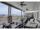 Relaxing covered patio with ceiling fans, stone accents, and comfortable seating for outdoor enjoyment at 6977 Copper Sky Cir, Castle Pines, CO 80108