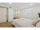 Bedroom with a modern aesthetic featuring a large mirror closet and a cozy bed with neutral linens at 252 N Pennsylvania St # 102, Denver, CO 80203