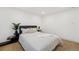 Bright bedroom with carpet flooring, large bed and modern accent tables at 252 N Pennsylvania St # 102, Denver, CO 80203