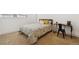 Comfortable bedroom featuring carpet flooring, a cozy bed, and a functional study desk at 252 N Pennsylvania St # 102, Denver, CO 80203