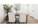 Dining area featuring a modern wood table, seating for four, and a stylish plant accent at 252 N Pennsylvania St # 102, Denver, CO 80203