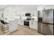 Modern kitchen featuring stainless steel appliances, bright white cabinets, and quartz countertops at 252 N Pennsylvania St # 102, Denver, CO 80203