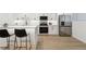 Bright kitchen with stainless steel appliances, quartz countertops, and a breakfast bar with seating at 252 N Pennsylvania St # 102, Denver, CO 80203
