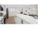 Modern kitchen with stainless appliances, a breakfast bar, and an open concept to the living area at 252 N Pennsylvania St # 102, Denver, CO 80203