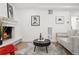 Bright living room featuring a fireplace, modern decor, and hardwood flooring at 252 N Pennsylvania St # 102, Denver, CO 80203