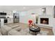 Cozy living space featuring a fireplace, hardwood floors, and an open layout to the kitchen at 252 N Pennsylvania St # 102, Denver, CO 80203